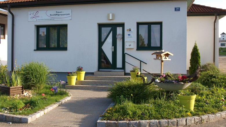 Luna Frauenprojekt, © LUNA Frauenprojekt Eingang eines kleinen Gebäudes mit Garten und Vogelhaus.