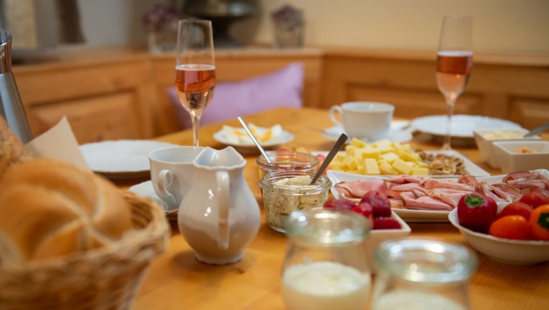 Delicious breakfast, © Tonality Breakfast table with bread rolls, cold cuts, cheese, champagne glasses and yogurt.