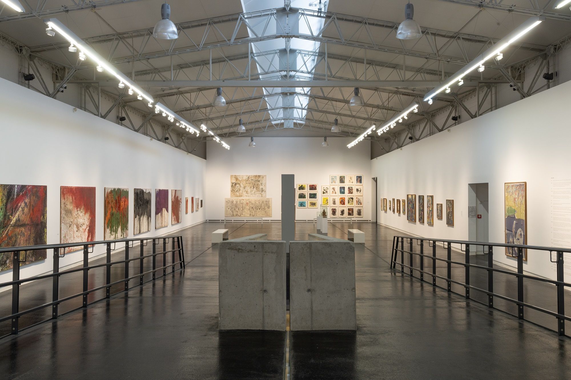 Interior view of the Nitsch Museum with paintings on the walls and modern architecture.