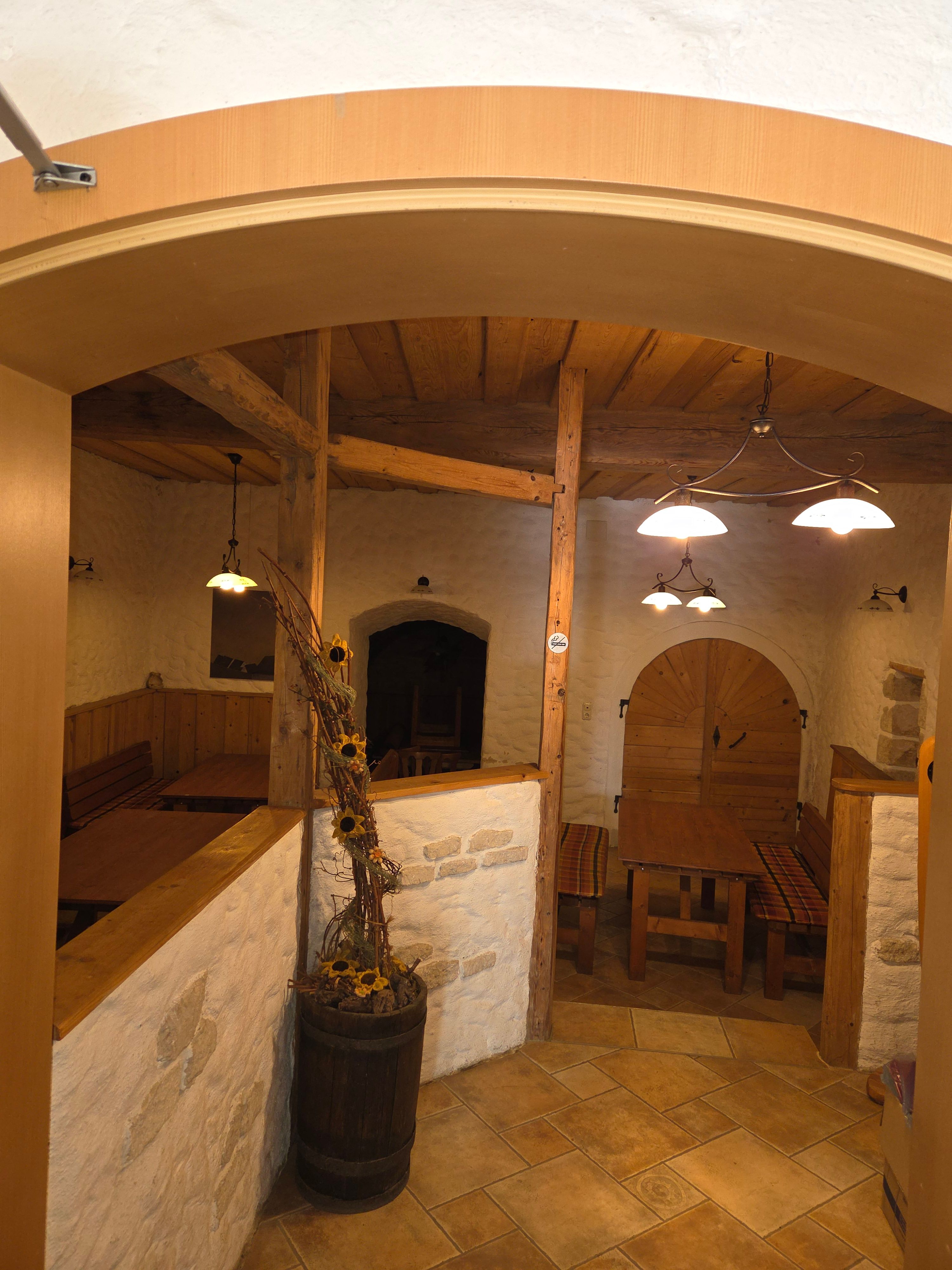 Cozy interior of a rustic inn with wooden furniture and decorations.