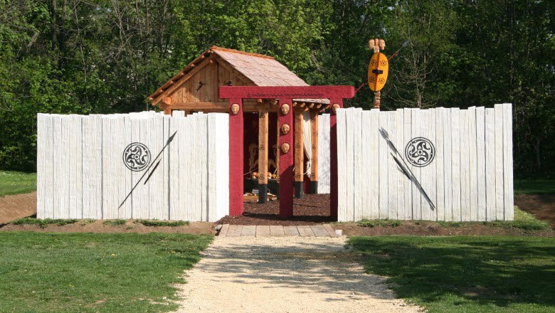 Reconstruction of a Celtic gate with wooden walls and decorations.