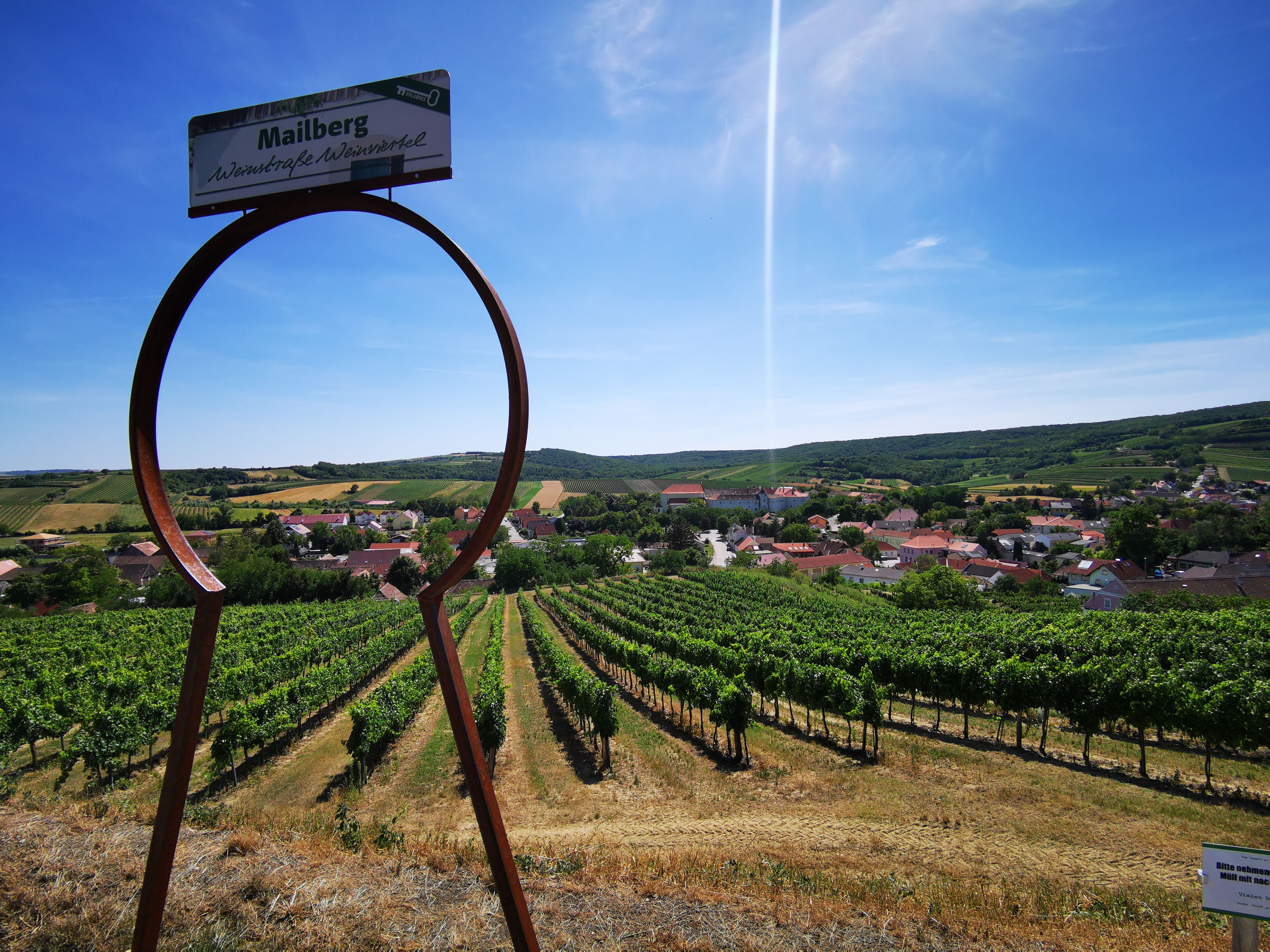 View of vineyards and village through a large keyhole symbol in Mailberg.