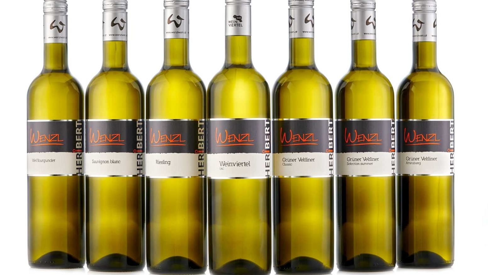 Seven Wenzl brand wine bottles in a row.