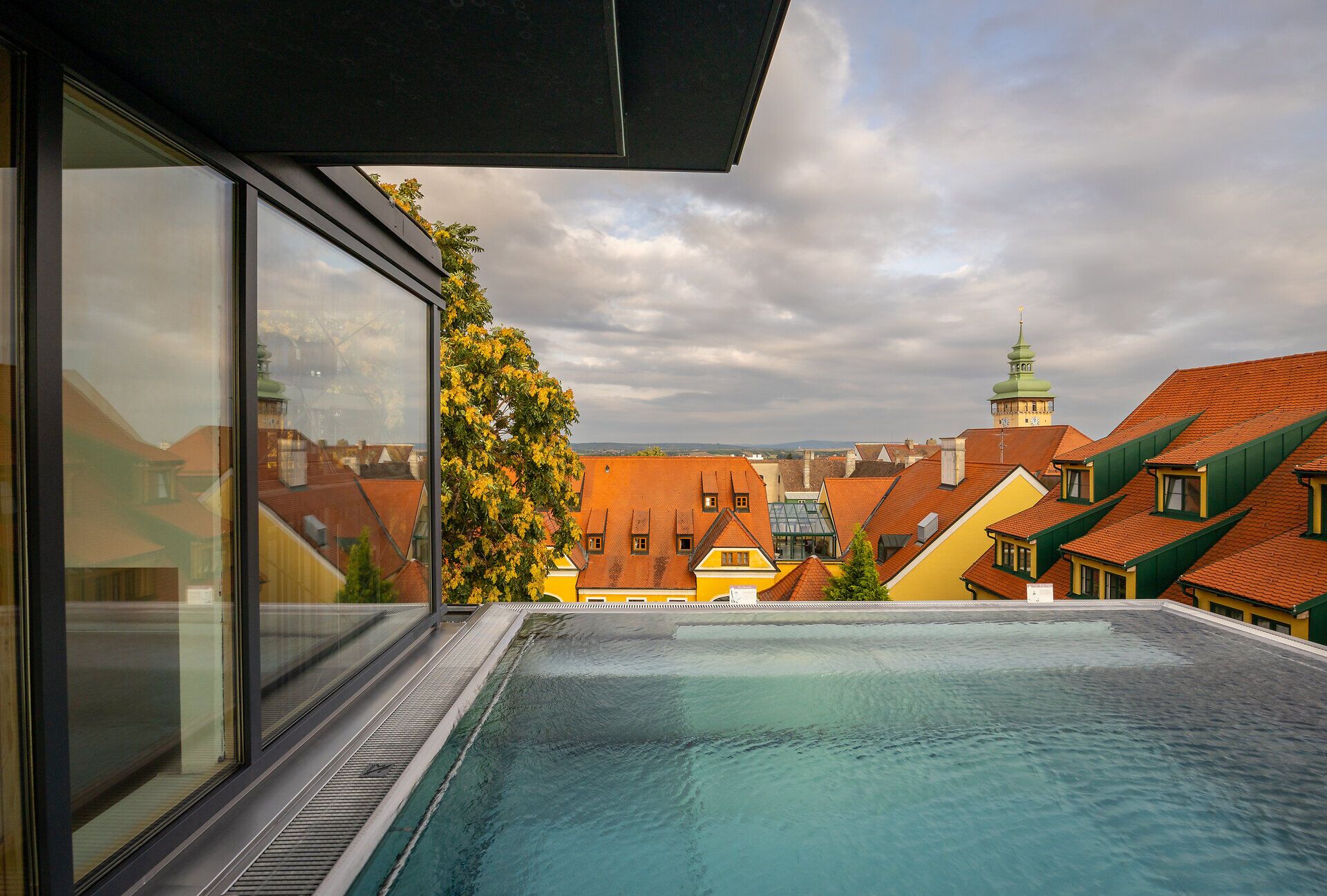 Ein atemberaubender Blick über die malerischen Dächer, während die sanften Hügel im Hintergrund die Landschaft umarmen. Die ruhige Atmosphäre lädt dazu ein, die Seele baumeln zu lassen und die Schönheit der Natur zu genießen.
