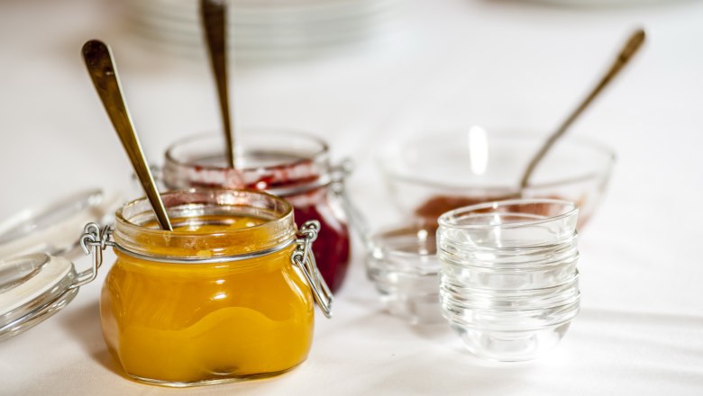 Close-up of jam jars on a table.