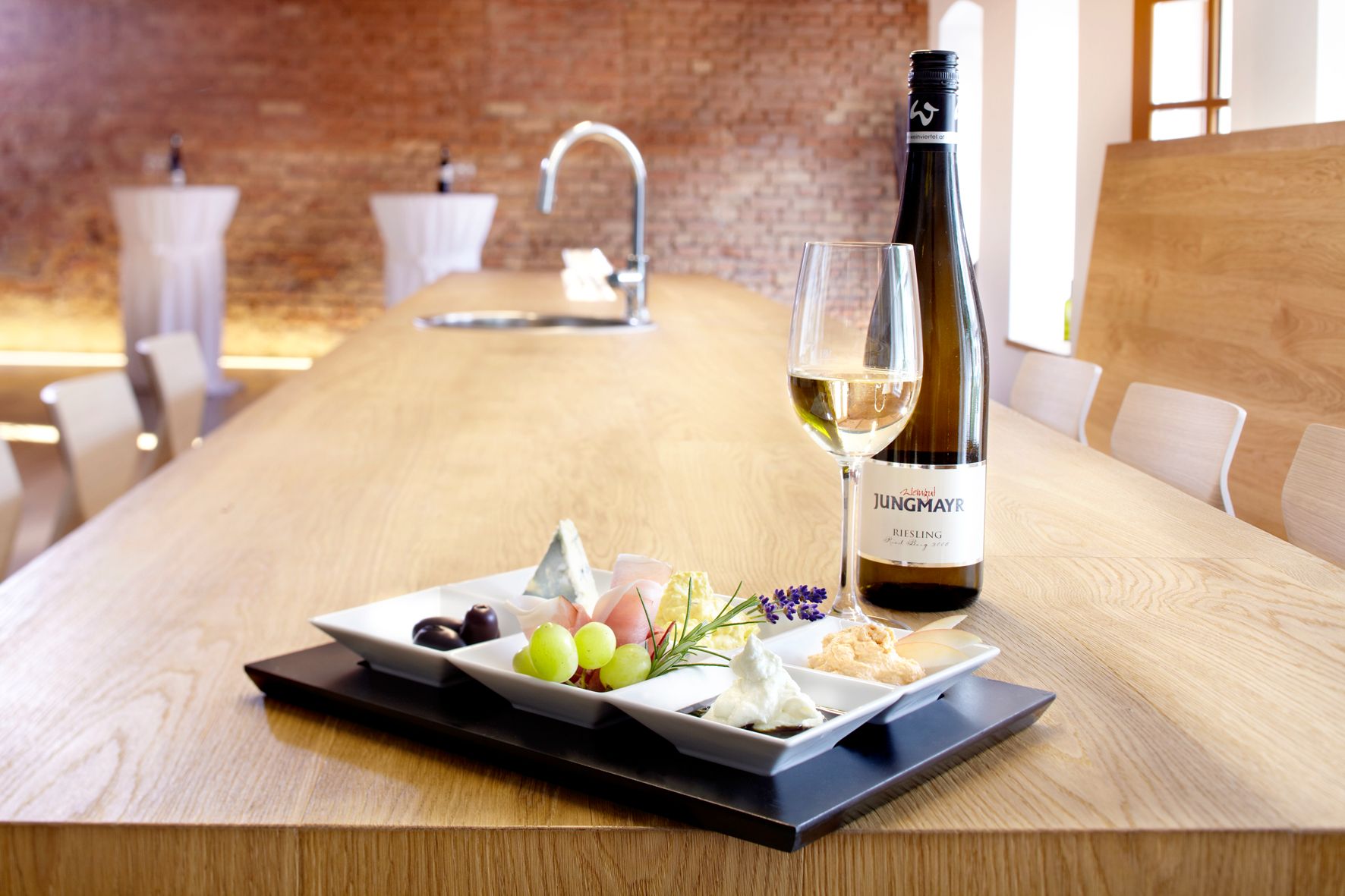 Wine and snacks on a table at the Jungmayr winery.