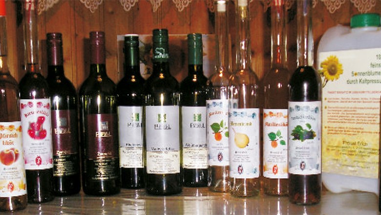 Various bottles of wines and liqueurs on a table.