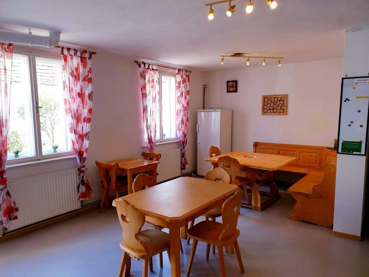 Cozy room with wooden furniture and red curtains.