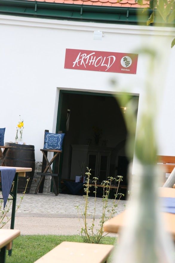 Entrance to a wine cellar with sign 'Arthold'.