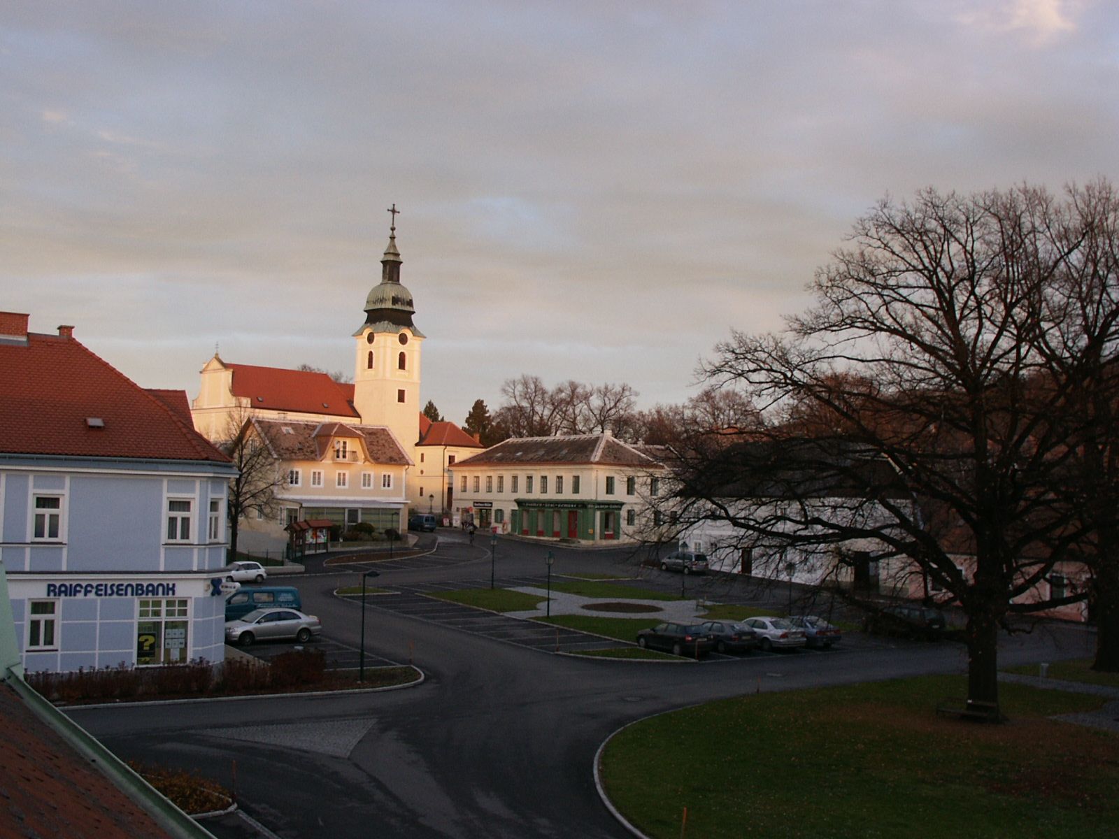 Main square of Sitzendorf with church and surrounding buildings at sunset.