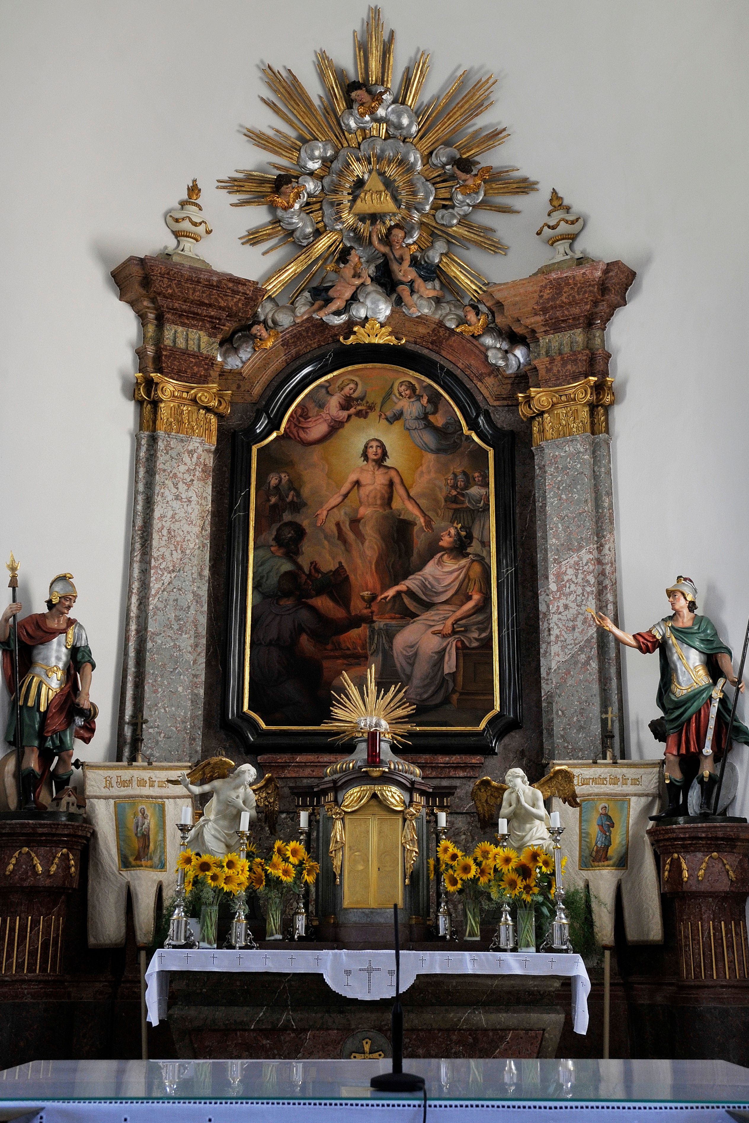 Altar in the church of Drasenhofen with religious painting and decorations.