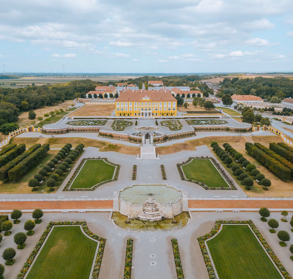 Die weitläufigen Terrassen von Schloss Hof laden zu einem entspannenden Spaziergang ein, umgeben von kunstvoll gestalteten Gärten und prächtigen Pflanzen. Hier entfaltet sich die Schönheit der Natur in harmonischer Verbindung mit der historischen Architektur, während sanfte Brisen die Luft erfüllen und die Sinne beleben.