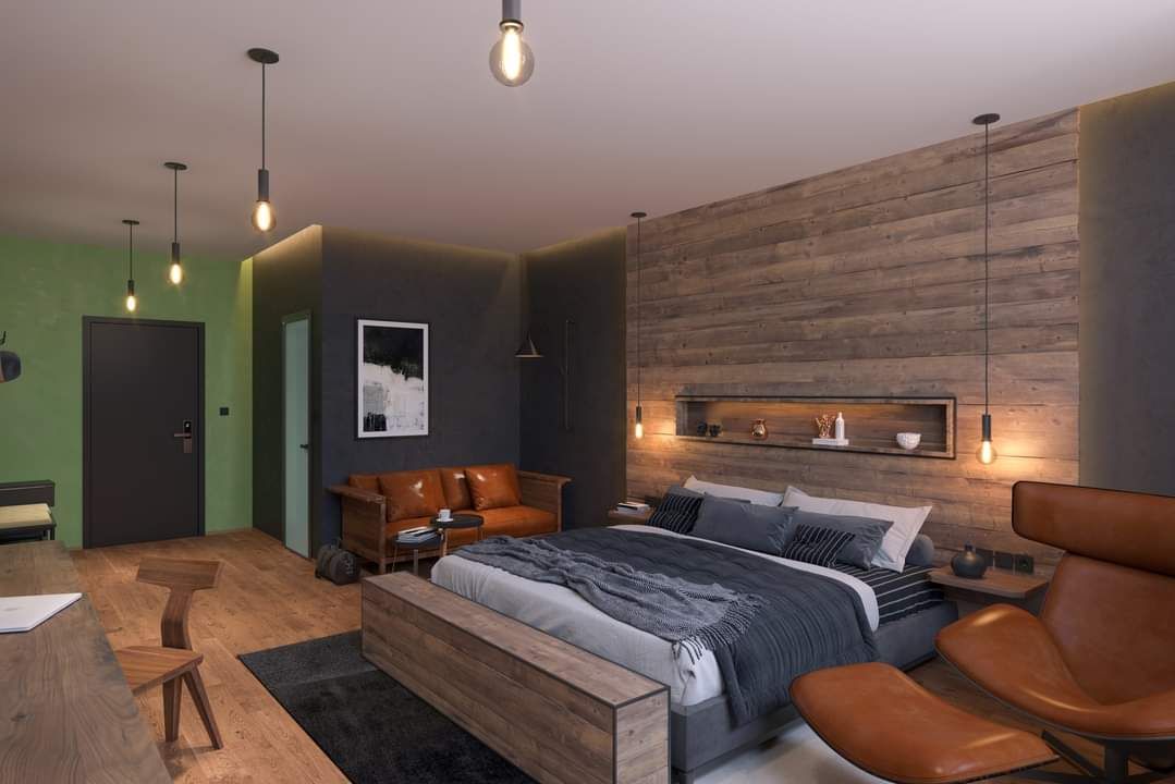 Modernes Schlafzimmer mit Holzwand, großem Bett, Ledersofa und stilvollen Lampen.