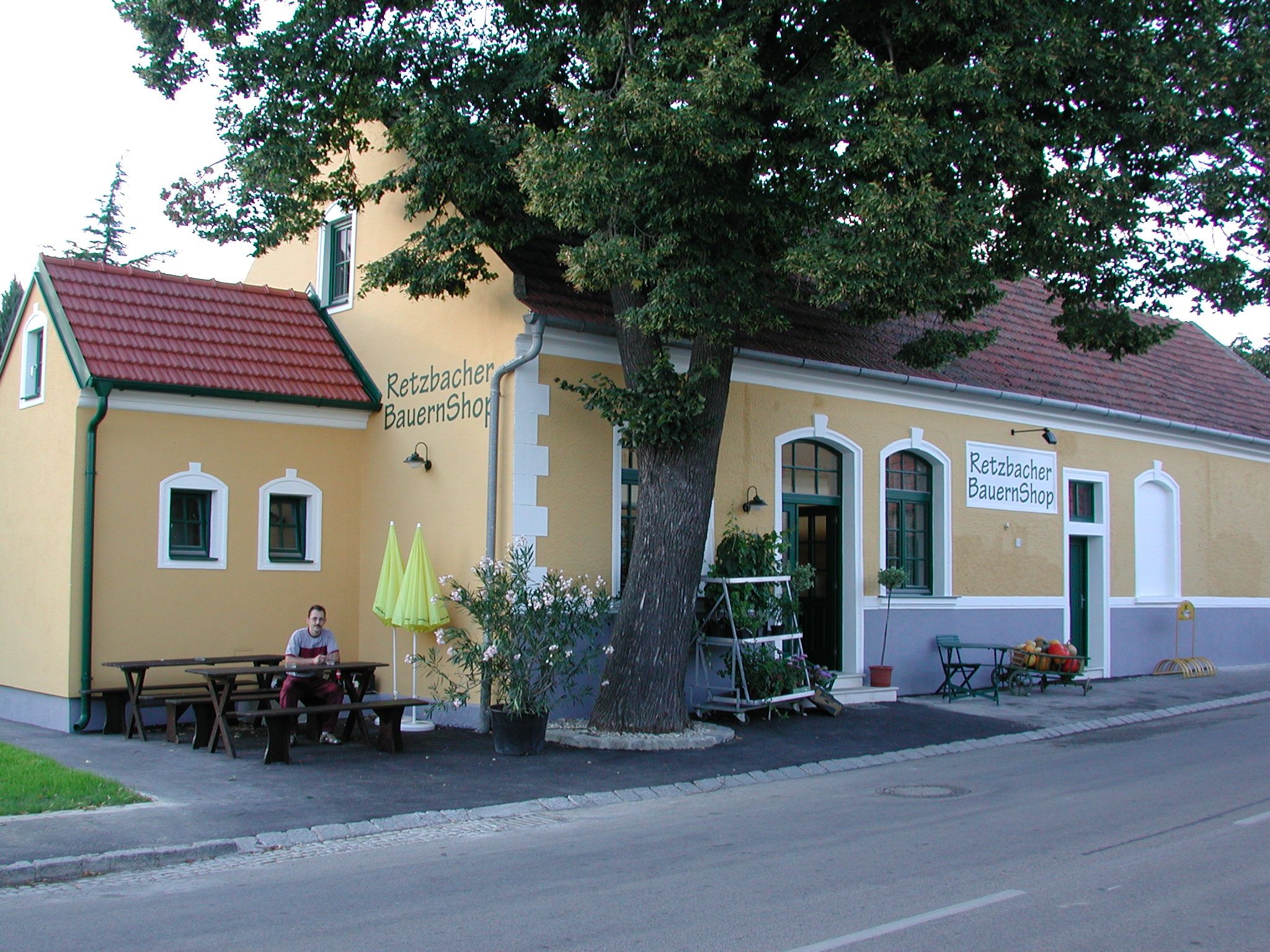 Außenansicht des Retzbacher BauernShops mit gelber Fassade und rotem Dach.