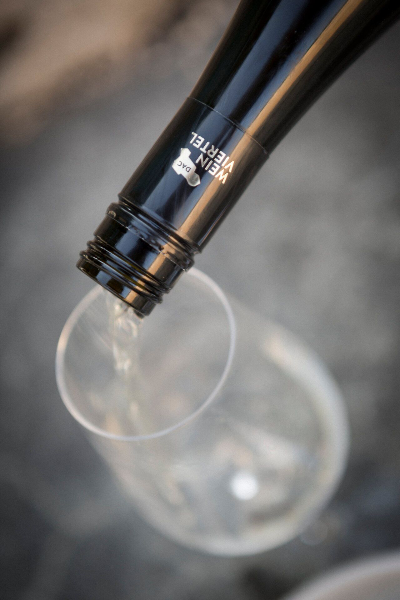 Ein elegantes Weinglas füllt sich mit dem klaren, goldenen Schimmer eines erlesenen Weins. Die sanften Hügel des Weinviertels laden dazu ein, die Aromen und die Vielfalt der regionalen Weine zu entdecken. Genießen Sie die harmonische Verbindung von Natur und Kulinarik in dieser malerischen Landschaft.