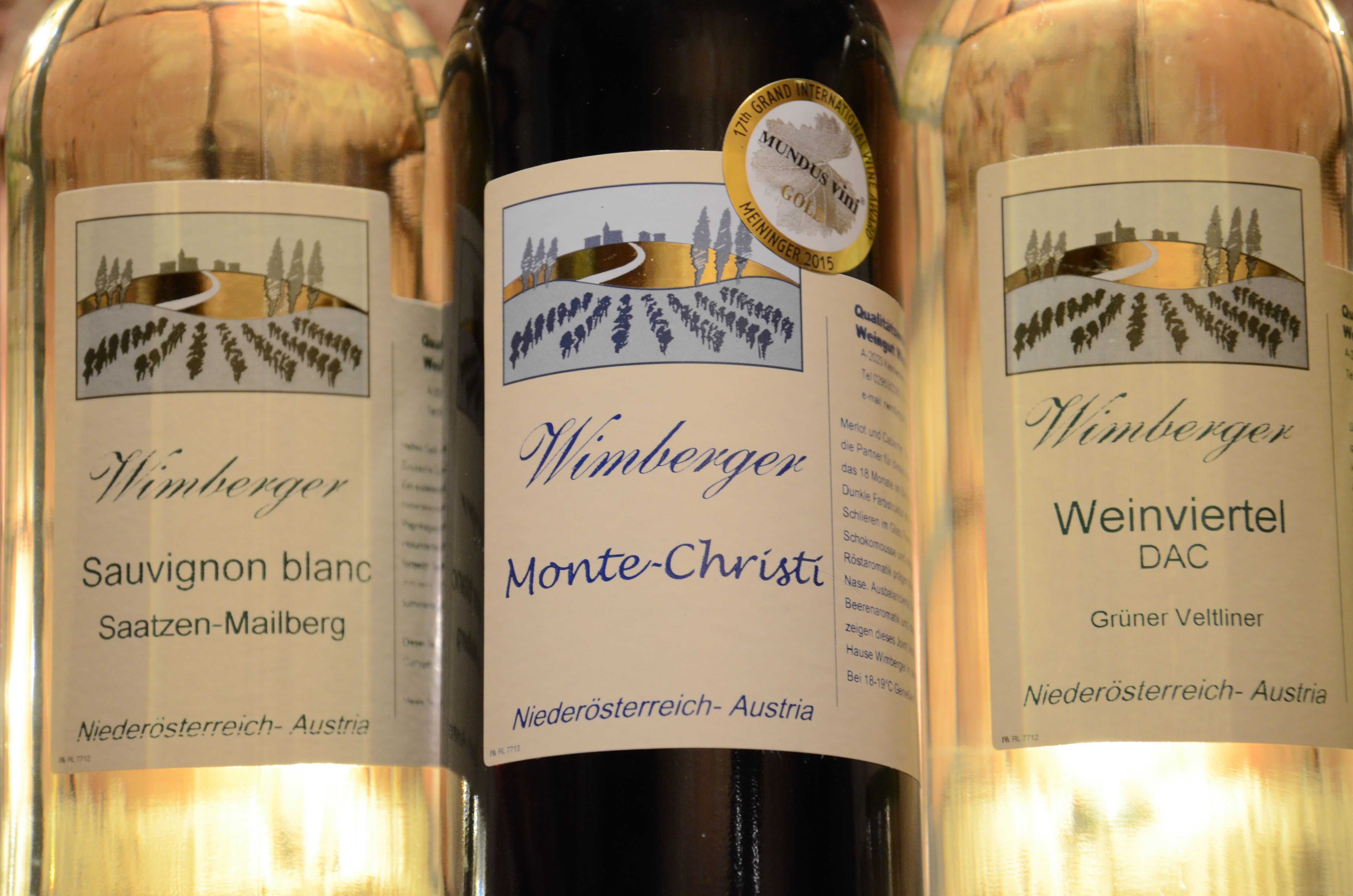 Three Wimberger brand wine bottles with labels for Sauvignon Blanc, Monte-Christi and Weinviertel DAC.