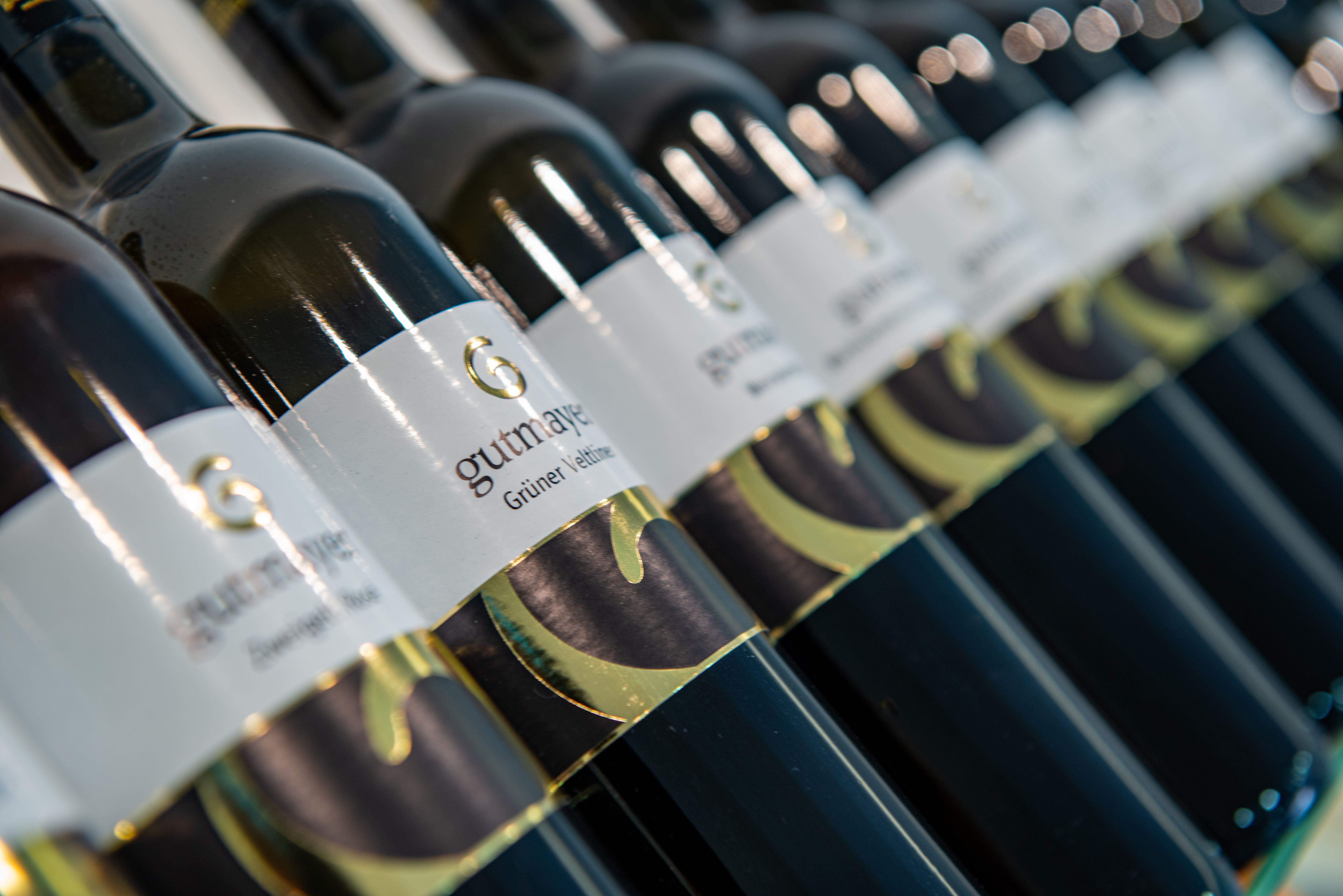 Close-up of wine bottles with the label 'Gutmayer Grüne Veltliner'.