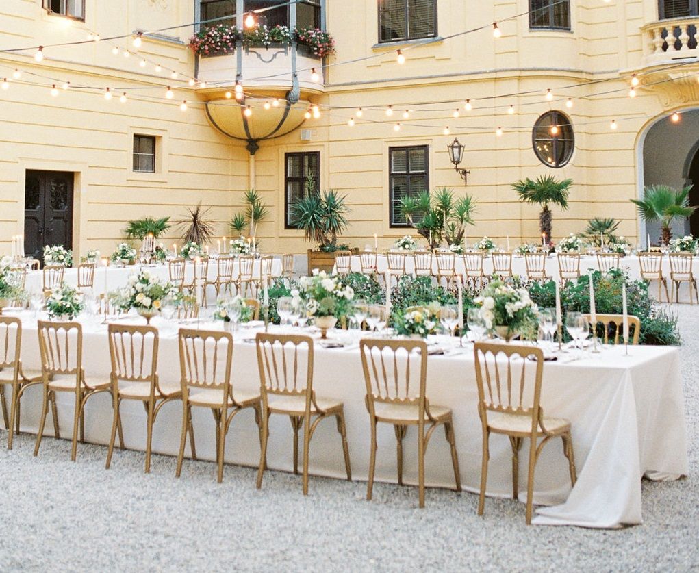 Inner courtyard of Schloss Eckartsau with festively laid tables and fairy lights.