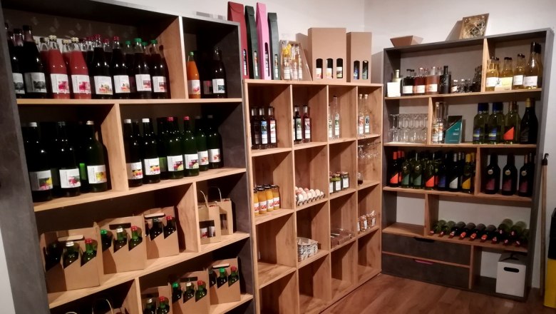 Shelves with various bottles and products in a farm store.