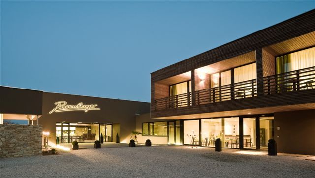 Modernes Gebäude des Weinguts Rosenberger bei Dämmerung mit beleuchtetem Schriftzug.