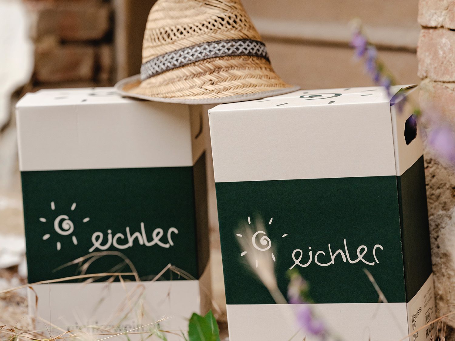 Two boxes with the inscription 'eichler' and a straw hat on them.