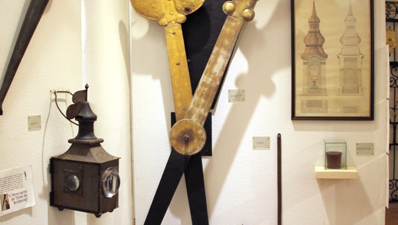 Exhibition in the Stockerau District Museum with old clock parts and drawings.