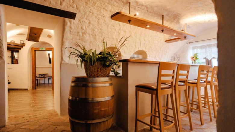 Cozy parlor with bar stools and rustic furnishings.