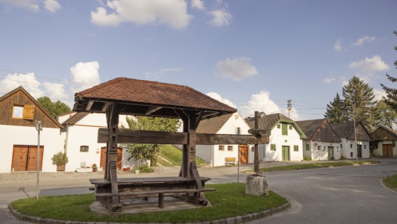 Historic wine press in Kettlasbrunn in front of traditional cellar lane houses.