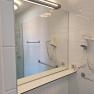 Modern bathroom with mirror, hairdryer and towel rail.