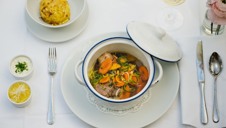 Traditional Tafelspitz dish on a white tablecloth.