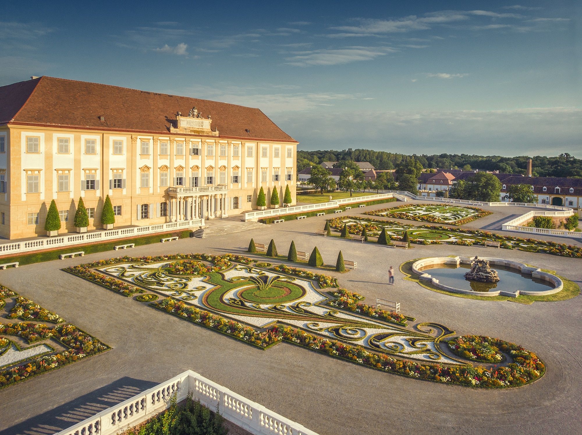 Schloss Hof with its magnificent baroque garden and fountain in sunny weather.