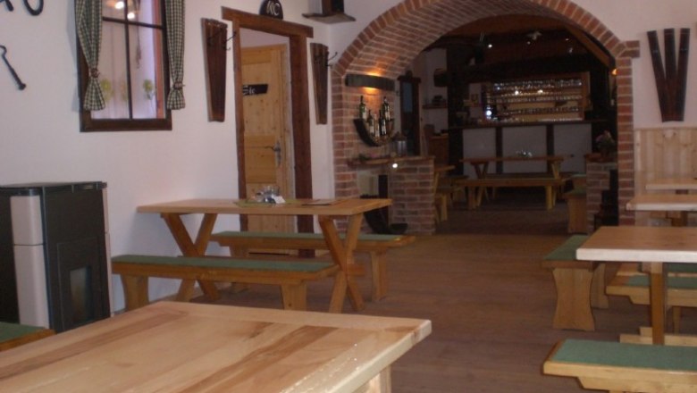 Interior view of a traditional wine tavern with wooden tables and benches.