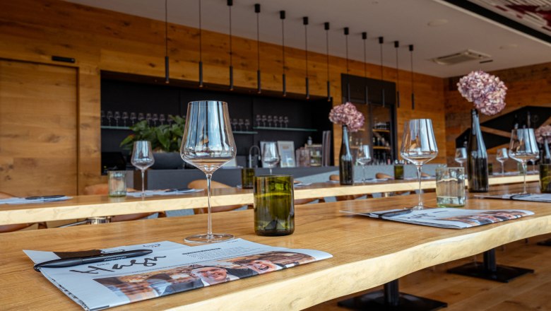 Interior view of a modern wine domicile with laid tables, wine glasses and decoration.